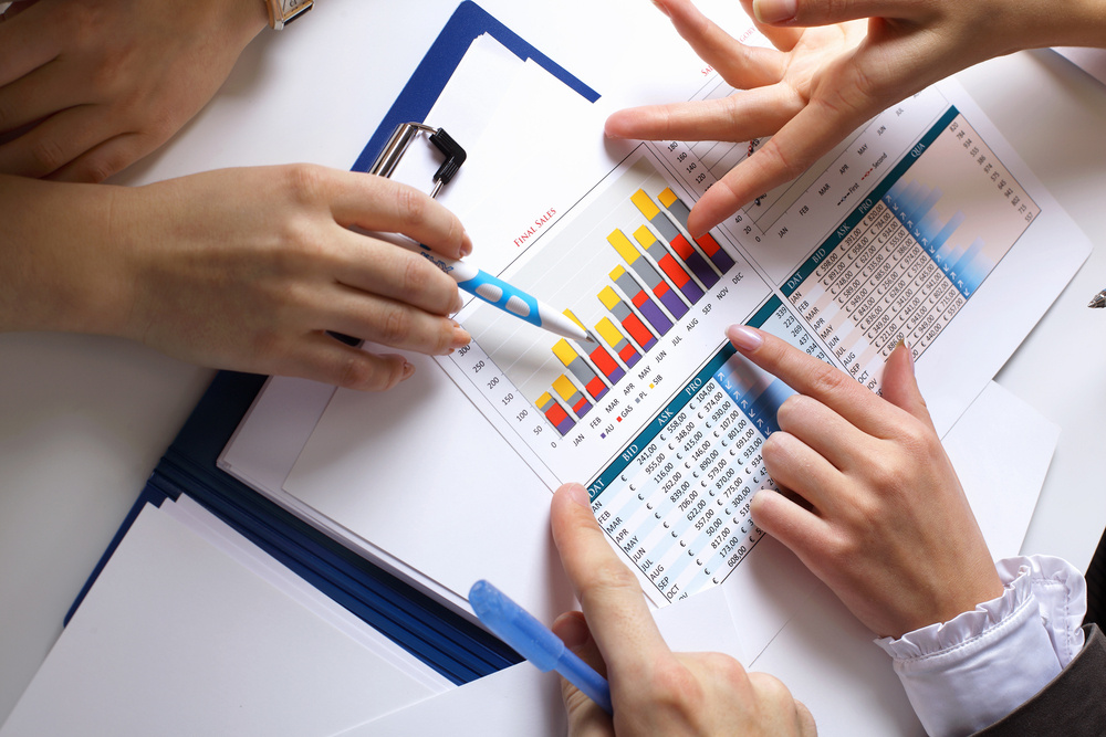 Financial paper charts and graphs on the table